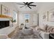 Inviting living room with a fireplace, stylish decor, and plenty of natural light at 2457 W Phillips Rd, Queen Creek, AZ 85144