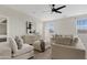 Comfortable living room featuring neutral tones, stylish decor, and a modern ceiling fan at 2457 W Phillips Rd, Queen Creek, AZ 85144