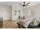 Comfortable main bedroom with ample natural light, a cozy chair, and an ensuite bathroom at 2457 W Phillips Rd, Queen Creek, AZ 85144