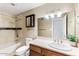 Bathroom with tiled shower, dark wood vanity, and sink at 2923 N 63Rd St, Mesa, AZ 85215