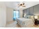 Bright bedroom featuring a ceiling fan, a decorative rug, and a large window with sheer curtains at 2923 N 63Rd St, Mesa, AZ 85215