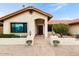 Welcoming home exterior with an arched entrance, custom door, and desert landscaping at 2923 N 63Rd St, Mesa, AZ 85215