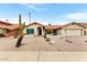 Charming home with desert landscaping, a red tile roof, and an attached two-car garage at 2923 N 63Rd St, Mesa, AZ 85215