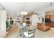 Bright open-concept living space with tile floors, modern lighting and an adjacent kitchen with wood cabinets at 2923 N 63Rd St, Mesa, AZ 85215