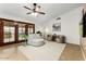 Cozy living room featuring tile floors, a ceiling fan, and a sliding glass door at 2923 N 63Rd St, Mesa, AZ 85215