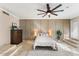 Elegant main bedroom featuring a ceiling fan, neutral walls, tile floors, and soft, ambient lighting at 2923 N 63Rd St, Mesa, AZ 85215