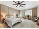 Spacious main bedroom with a ceiling fan, neutral walls, and a step-up to a private outdoor space at 2923 N 63Rd St, Mesa, AZ 85215