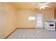 A view of the kitchen area showing tile floors, ceiling fan and access to an exit at 2928 W Cactus Rd, Phoenix, AZ 85029