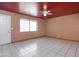 Bright, open living room with tile floors, neutral walls, ceiling fan, and access to other areas of the home at 2928 W Cactus Rd, Phoenix, AZ 85029