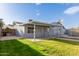 A spacious backyard features a well-maintained lawn and a covered patio, ideal for outdoor entertaining at 3027 S Clementine Dr, Tempe, AZ 85282