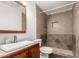 Bathroom featuring tiled shower, tile floors, framed mirror and light wood vanity at 3027 S Clementine Dr, Tempe, AZ 85282