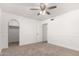 Neutral bedroom with ceiling fan and archway into closet at 3027 S Clementine Dr, Tempe, AZ 85282