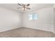 Neutral bedroom with ceiling fan and a window overlooking the yard at 3027 S Clementine Dr, Tempe, AZ 85282