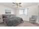 Cozy bedroom with plush carpeting, a ceiling fan, and a sunny window with neighborhood view at 3027 S Clementine Dr, Tempe, AZ 85282