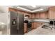 Modern kitchen with stainless steel appliances, wood cabinets, and granite countertops at 3027 S Clementine Dr, Tempe, AZ 85282