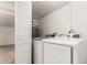 Laundry room with modern washer and dryer, water heater, and bifold doors at 3027 S Clementine Dr, Tempe, AZ 85282