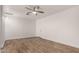 Living room with wood look tile, modern ceiling fan, and white walls at 3027 S Clementine Dr, Tempe, AZ 85282