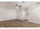 Spacious living room featuring wood look tile, modern ceiling fan, and white walls at 3027 S Clementine Dr, Tempe, AZ 85282