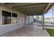 Covered patio with stone floors, access to backyard, and light gray exterior at 3027 S Clementine Dr, Tempe, AZ 85282