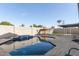 An outdoor pool with clear blue water, surrounded by a concrete block wall and brick pavers at 3027 S Clementine Dr, Tempe, AZ 85282