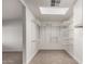 Spacious walk-in closet with skylight and ample shelving for organized storage at 3027 S Clementine Dr, Tempe, AZ 85282