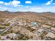 Desert homes aerial view with pools and solar panels, set against a mountain backdrop at 32754 N 15Th Gln, Phoenix, AZ 85085