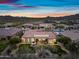 Stunning aerial view of desert home with red tile roof and colorful sunset at 32754 N 15Th Gln, Phoenix, AZ 85085