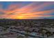 Stunning aerial view of a residential neighborhood with a vibrant sunset backdrop at 32754 N 15Th Gln, Phoenix, AZ 85085