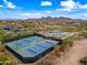 Aerial view of community tennis and basketball courts nestled in a desert landscape at 32754 N 15Th Gln, Phoenix, AZ 85085