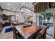 Elegant dining room with stylish lighting, wood table, and sliding doors to the outdoor space at 32754 N 15Th Gln, Phoenix, AZ 85085