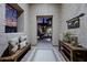 Elegant entryway featuring a cushioned bench, rug, decorative table, and villa sign at 32754 N 15Th Gln, Phoenix, AZ 85085