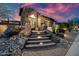 Beautiful stone home entrance with boulder landscaping, lit stairway and arched door at 32754 N 15Th Gln, Phoenix, AZ 85085