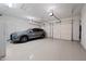 Spacious three car garage with epoxy floor and a gray SUV at 32754 N 15Th Gln, Phoenix, AZ 85085