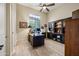 This well-lit home office features a desk and large display cabinet at 32754 N 15Th Gln, Phoenix, AZ 85085