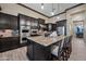 Stylish kitchen featuring dark cabinets, a large center island, and stainless steel appliances at 32754 N 15Th Gln, Phoenix, AZ 85085