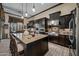 Spacious kitchen featuring a large island, dark cabinetry, and stainless steel appliances at 32754 N 15Th Gln, Phoenix, AZ 85085