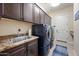 This laundry room features washer, dryer, sink, and storage cabinets at 32754 N 15Th Gln, Phoenix, AZ 85085