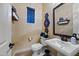 This powder room features decor, a toilet, and a sink at 32754 N 15Th Gln, Phoenix, AZ 85085