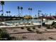 Community pool with lounge chairs, cabanas, and palm trees, offering a resort-style experience at 328 E Aztec Blvd, Mesa, AZ 85205