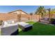 Well-designed backyard featuring artificial turf, inviting patio seating, swing, and stylish decor at 3284 W Five Mile Peak Dr, San Tan Valley, AZ 85144