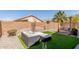 Charming backyard with artificial turf, comfortable patio seating, swing, and stylish backyard decor at 3284 W Five Mile Peak Dr, San Tan Valley, AZ 85144