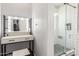 Bright bathroom featuring a vanity area with illuminated mirror and tiled shower at 3284 W Five Mile Peak Dr, San Tan Valley, AZ 85144