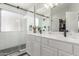 Modern bathroom with dual sinks, subway tiled shower, and a view to a closet at 3284 W Five Mile Peak Dr, San Tan Valley, AZ 85144