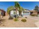 Single-story home showcasing a xeriscaped front yard, and attached two-car garage at 3284 W Five Mile Peak Dr, San Tan Valley, AZ 85144