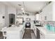 Modern white kitchen with stainless steel appliances and stylish tile backsplash at 3284 W Five Mile Peak Dr, San Tan Valley, AZ 85144