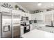 Well-lit kitchen with stainless steel appliances, white cabinetry and granite counters at 3284 W Five Mile Peak Dr, San Tan Valley, AZ 85144