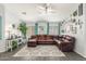 Comfortable living room with a large brown leather sofa and stylish decor at 3284 W Five Mile Peak Dr, San Tan Valley, AZ 85144