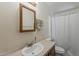 Well-lit bathroom featuring a vanity sink, mirror, and a toilet beside a bathtub with a shower curtain at 3330 E Main St # 7, Mesa, AZ 85213