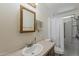 Bathroom featuring vanity sink, mirror, and a toilet adjacent to a shower with accessible grab bars at 3330 E Main St # 7, Mesa, AZ 85213