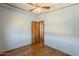 Bedroom showing neutral-toned walls, warm wood-look flooring, and a door leading to another area of the house at 3330 E Main St # 7, Mesa, AZ 85213